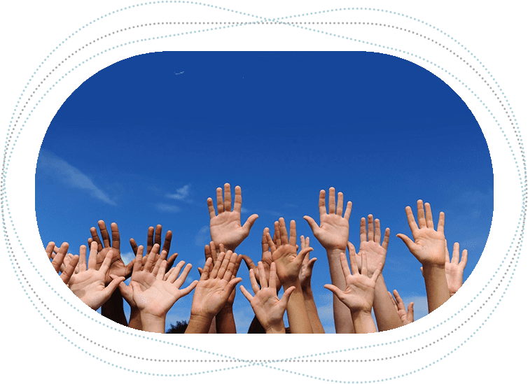 A group of people raising their hands in the air.